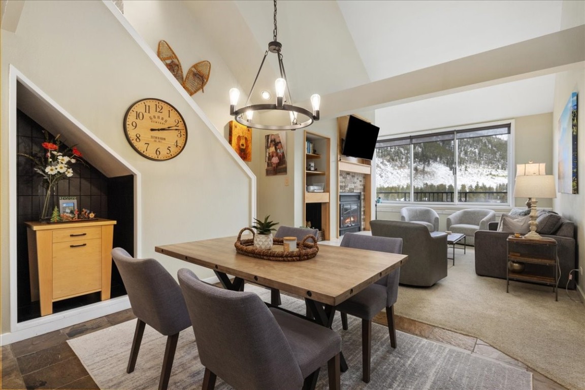 21650 Highway 6, Unit 2106 Keystone, CO 80435 - Photo 44 of 44 a dining room with furniture a large window and a clock