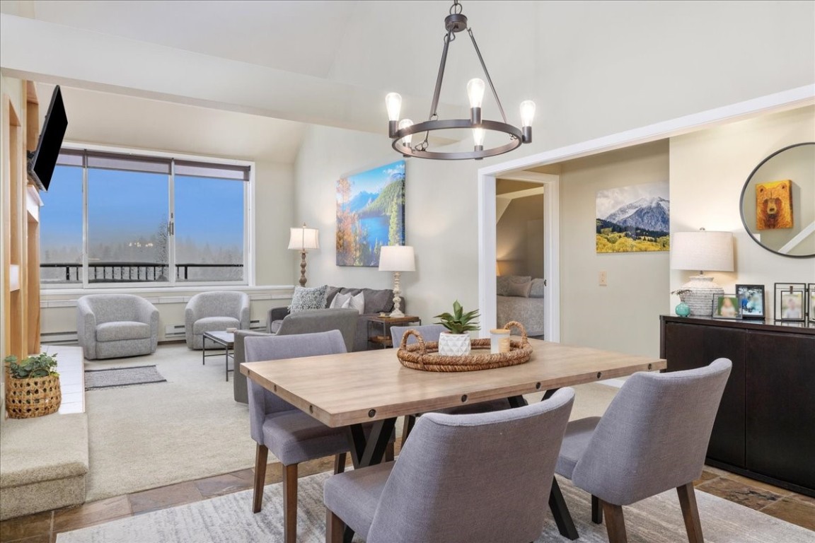 21650 Highway 6, Unit 2106 Keystone, CO 80435 - Photo 6 of 44 a view of a dining room with furniture window and wooden floor