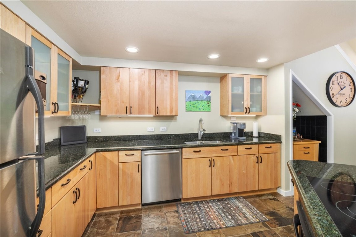 21650 Highway 6, Unit 2106 Keystone, CO 80435 - Photo 7 of 44 a kitchen with stainless steel appliances granite countertop a stove a sink and a refrigerator