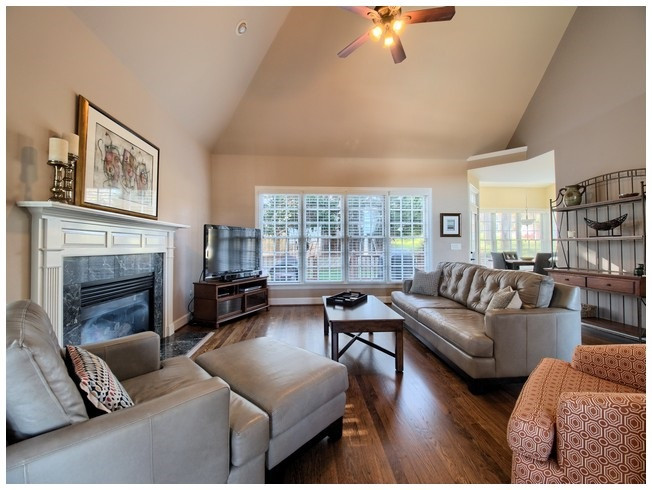 8000 Kukui Court Raleigh, NC 27613 - Photo 9 of 25 The large family room features a wall of windows overlooking the private back yard, vaulted ceiling and gas fireplace. Family Room
