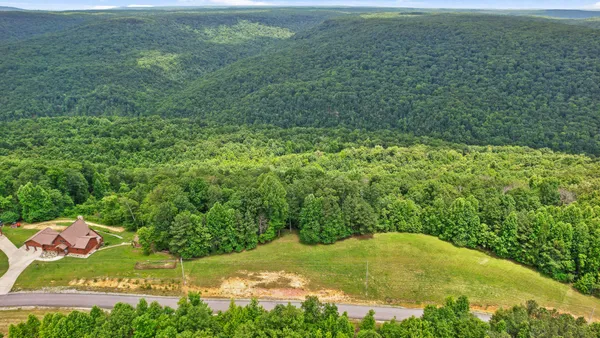 a view of a field with an ocean view