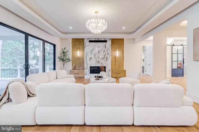 a spacious bedroom with a bed and a chandelier
