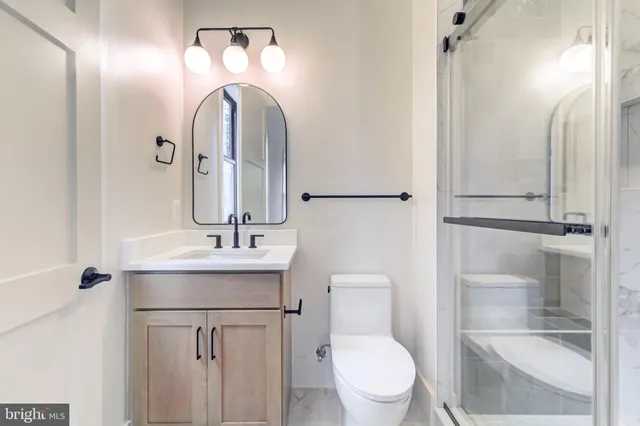 a view of empty room with wooden floor and windows