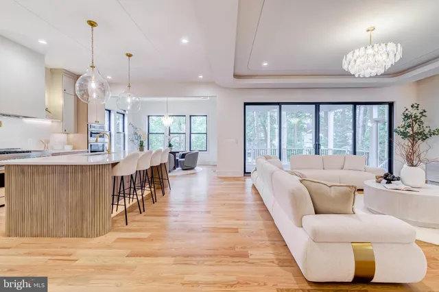 a view of a dining room with furniture and a chandelier