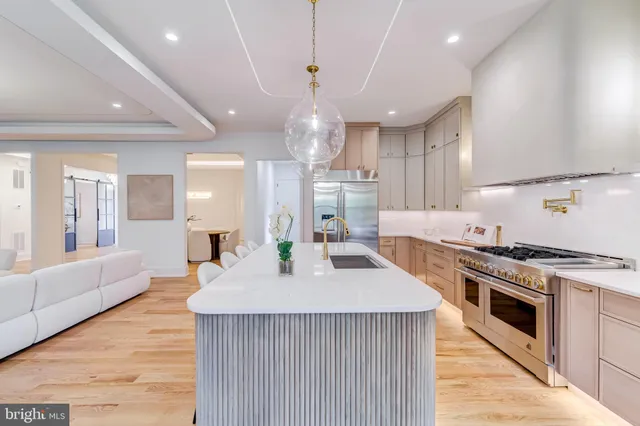 a living room with fireplace furniture and a large window