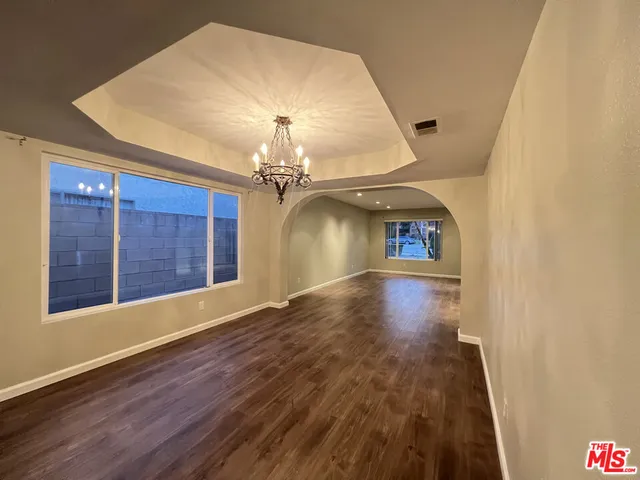 a kitchen with granite countertop a stove and a refrigerator