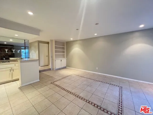 a view of kitchen with stainless steel appliances kitchen island a sink and a large window