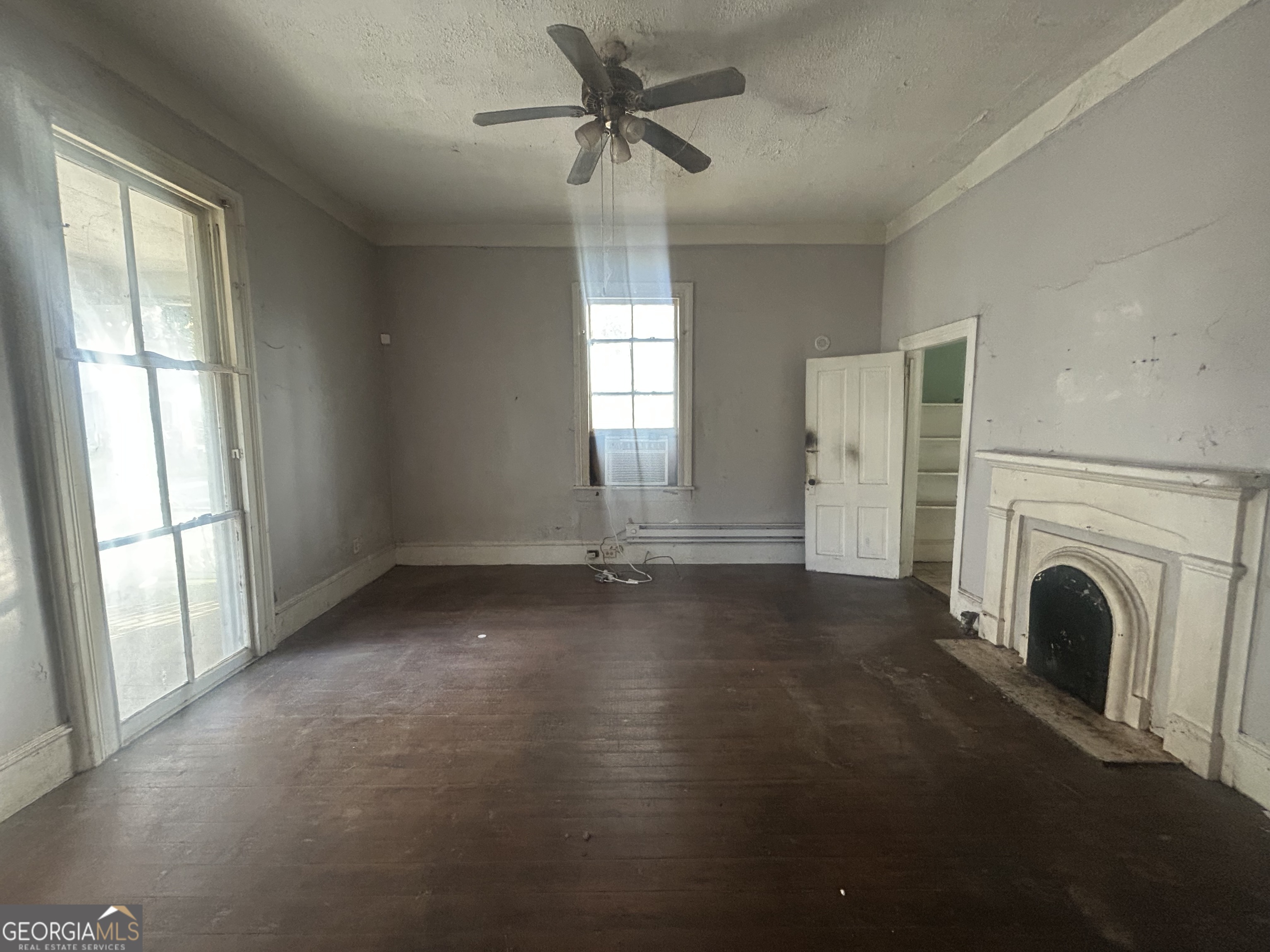 508 Albemarle Street, Unit AD Brunswick, GA 31520 - Photo 22 of 45 a view of a livingroom with a fireplace a ceiling fan and windows