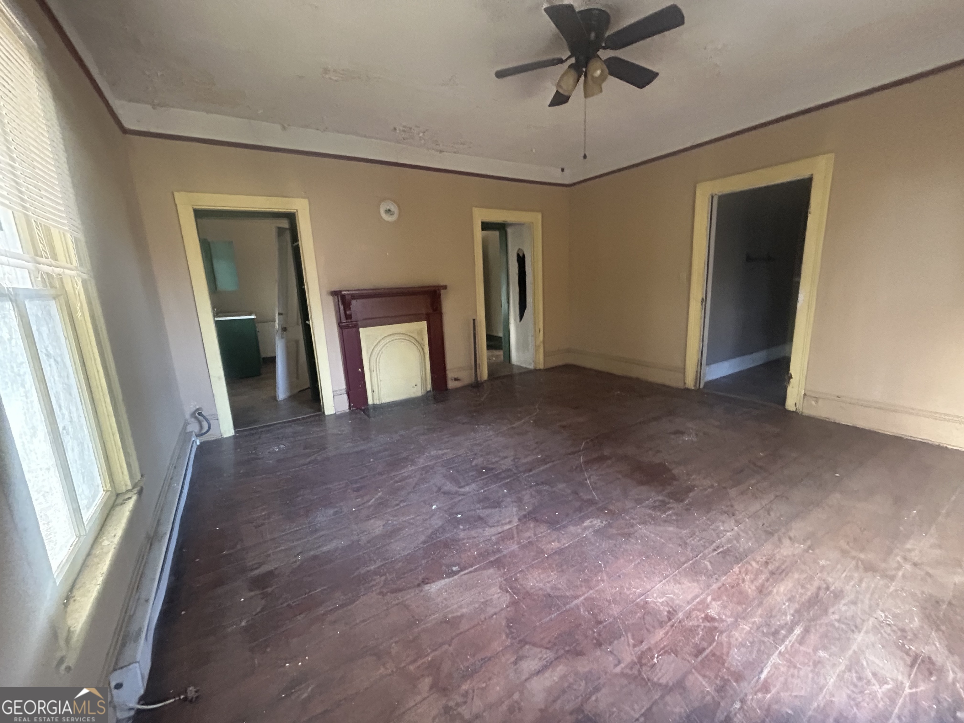 508 Albemarle Street, Unit AD Brunswick, GA 31520 - Photo 31 of 45 an empty room with chandelier fan and windows