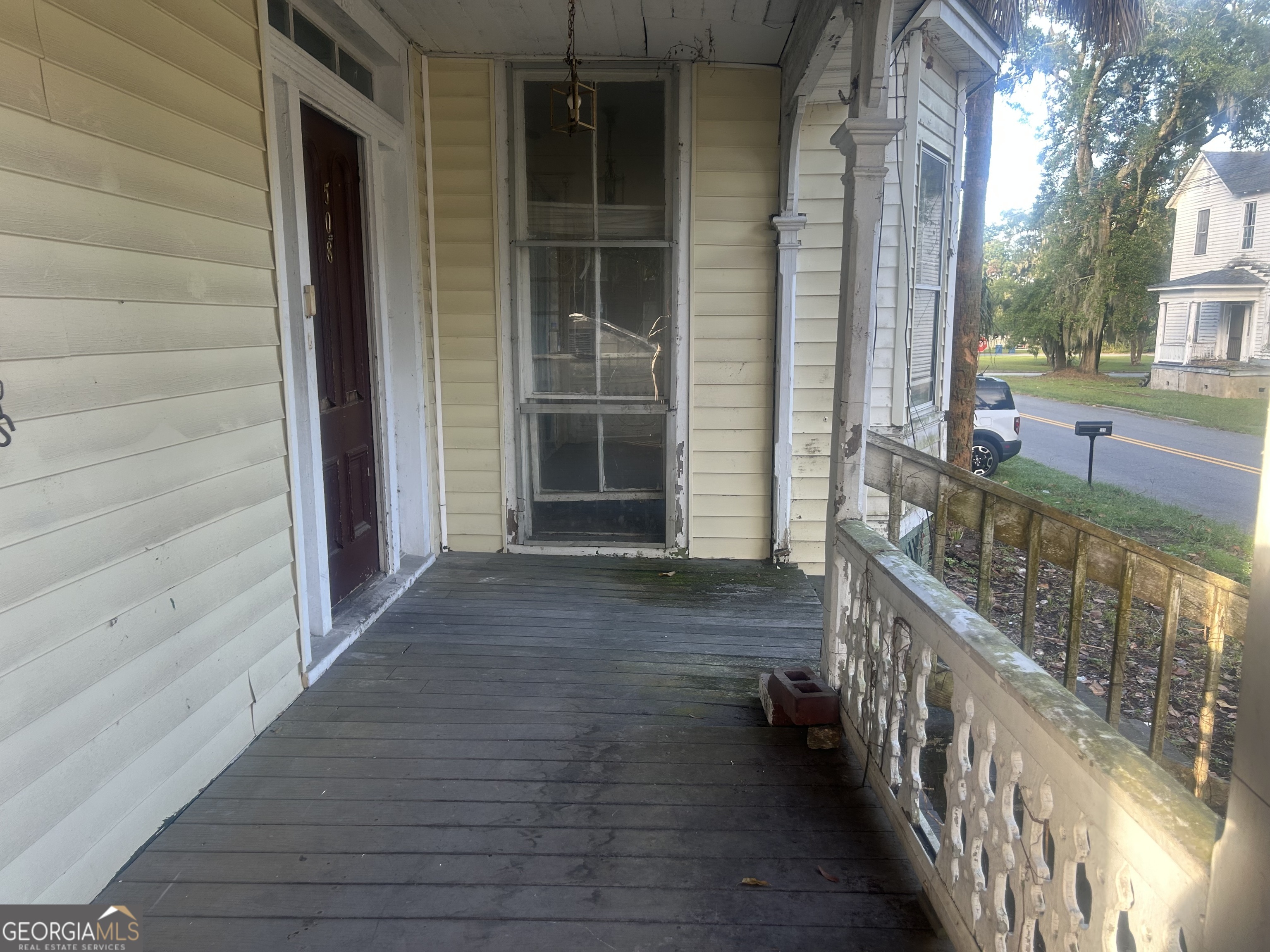 508 Albemarle Street, Unit AD Brunswick, GA 31520 - Photo 40 of 45 a view of a porch with wooden floor and stairs