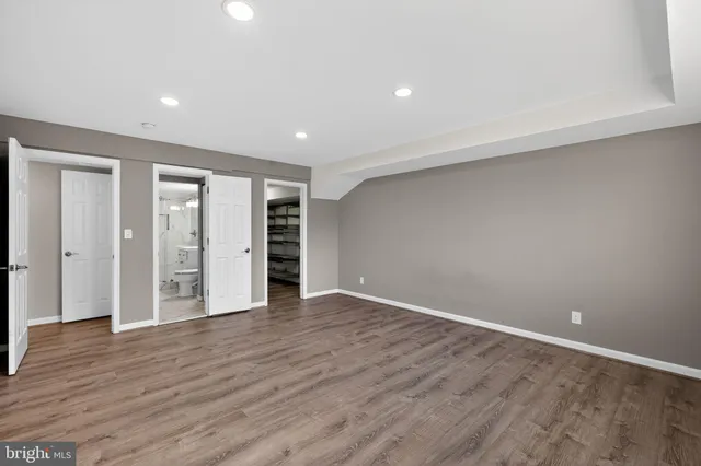 a view of an empty room with wooden floor