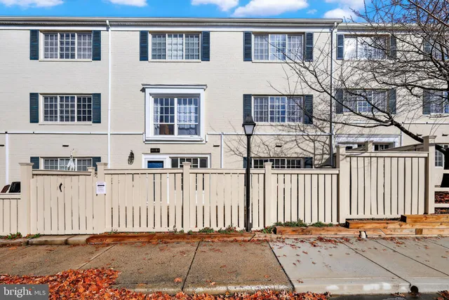 a front view of a house with a wooden fence