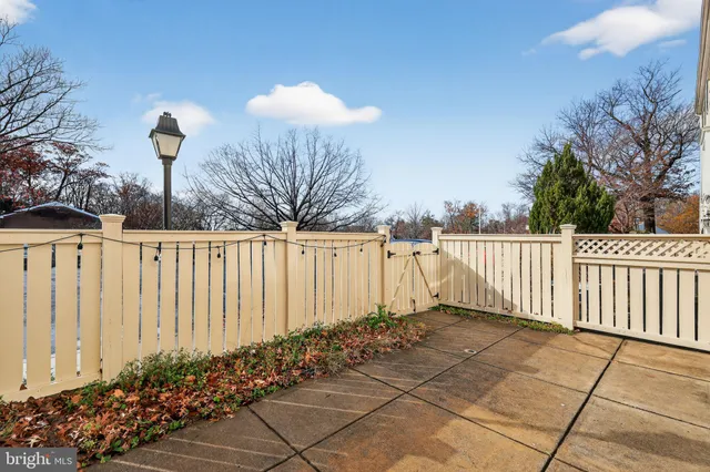 a view of a street with a fence