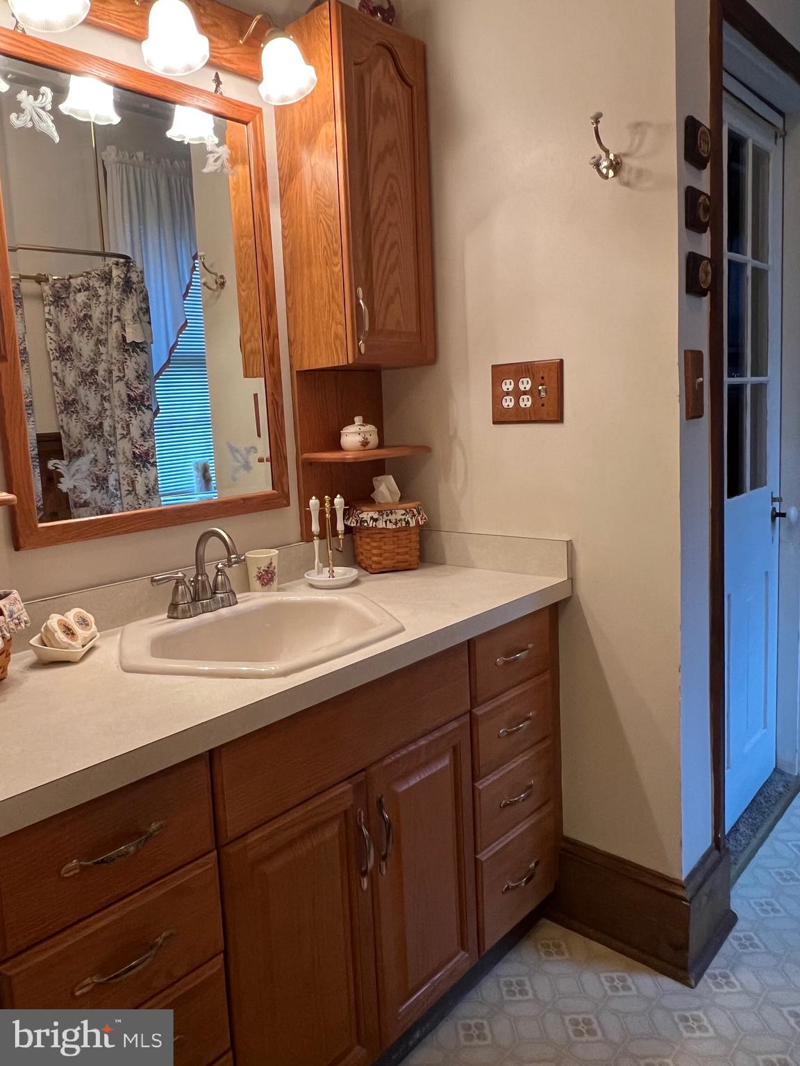 424 Jennings Street Beverly, NJ 08010 - Photo 24 of 43 a bathroom with a sink and a mirror