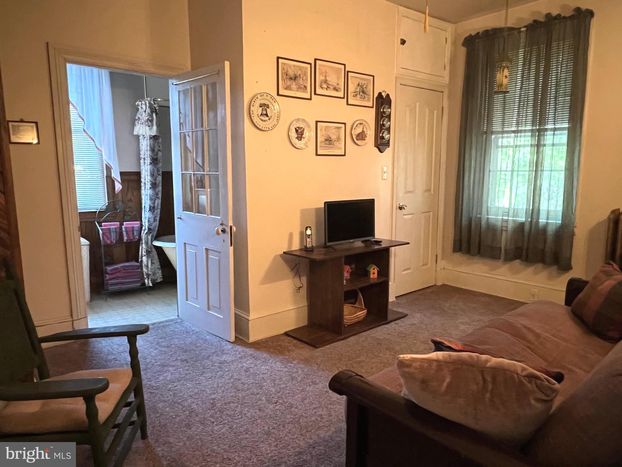424 Jennings Street Beverly, NJ 08010 - Photo 25 of 43 a living room with furniture and a flat screen tv