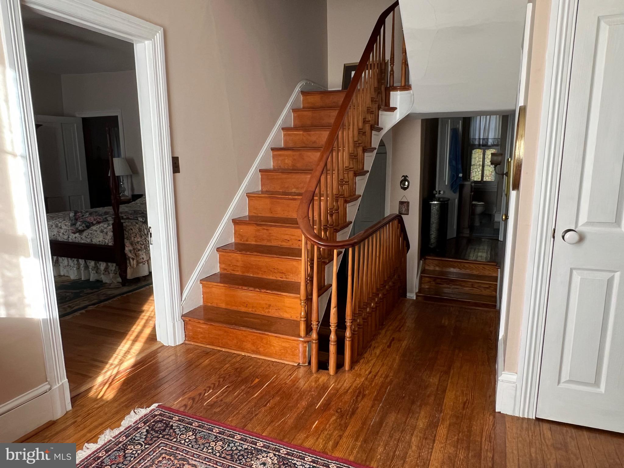 424 Jennings Street Beverly, NJ 08010 - Photo 28 of 43 a view of a hallway with wooden floor and staircase