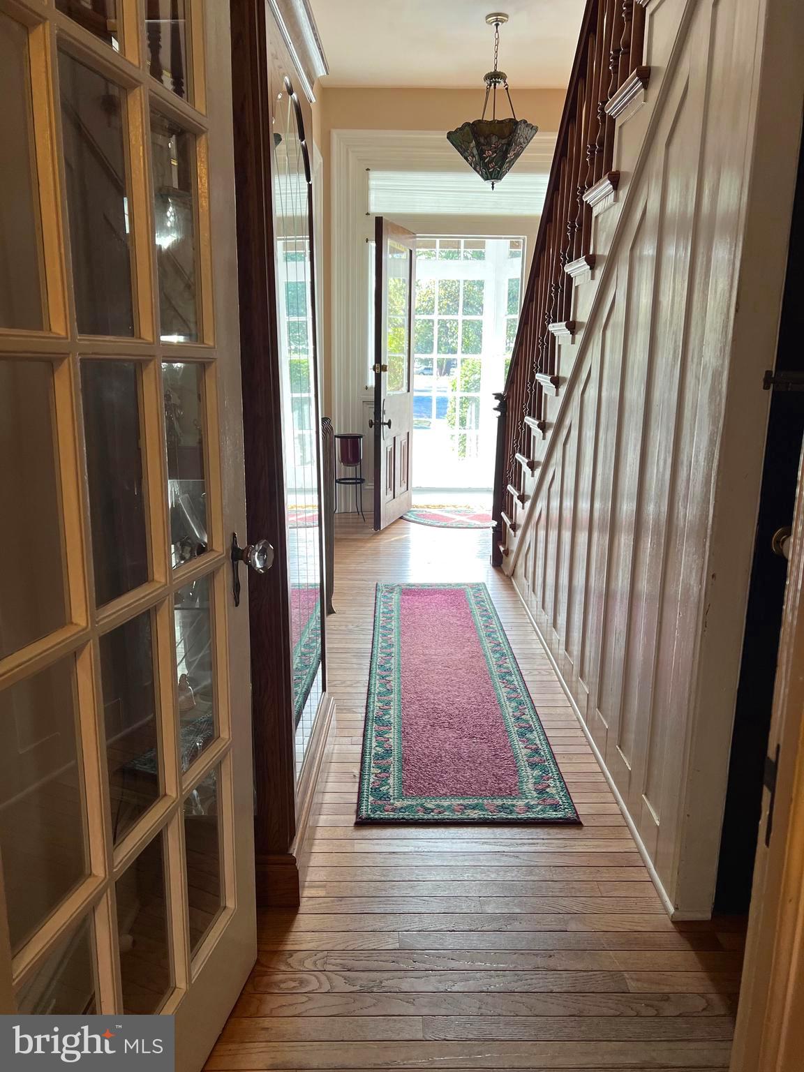 424 Jennings Street Beverly, NJ 08010 - Photo 6 of 43 a view of a hallway with wooden floor and staircase