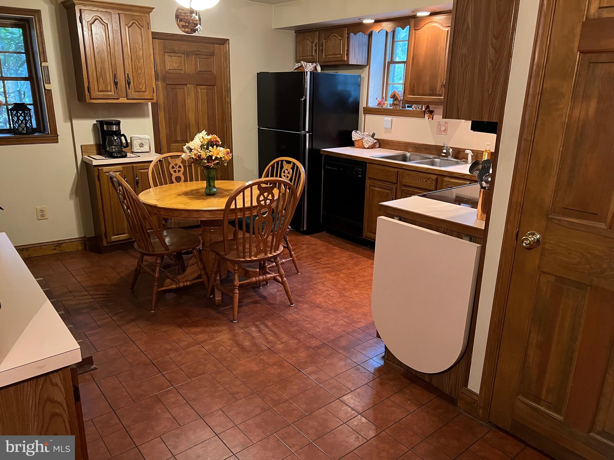 424 Jennings Street Beverly, NJ 08010 - Photo 10 of 43 a kitchen with refrigerator and chairs