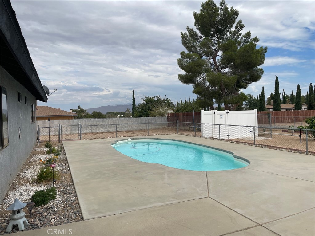 14961 Walnut Street Hesperia, CA 92345 - Photo 25 of 25 a swimming pool with outdoor seating and barbeque oven