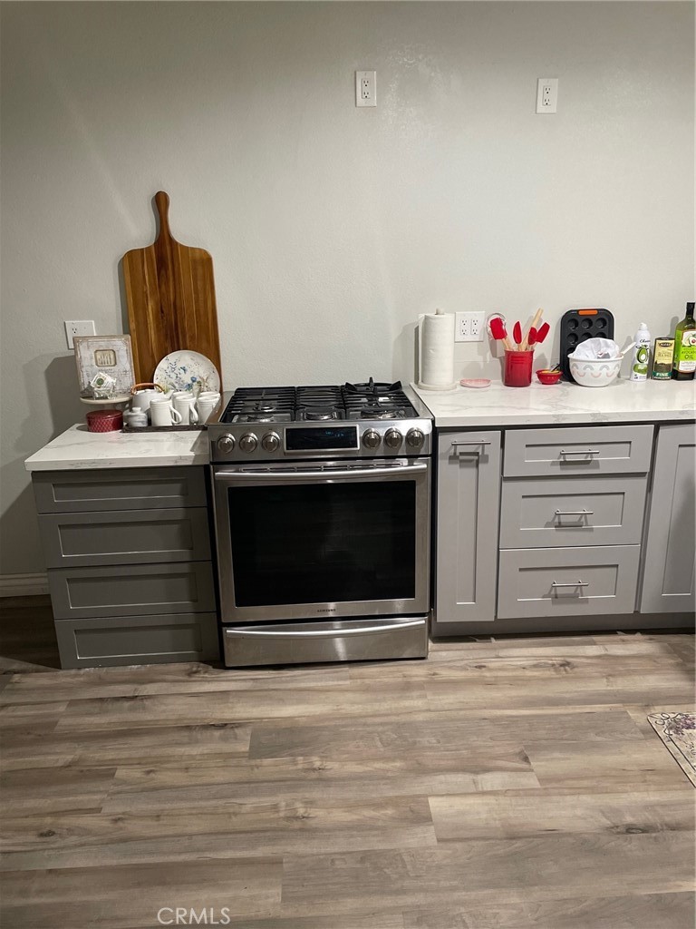 14961 Walnut Street Hesperia, CA 92345 - Photo 3 of 25 a kitchen with a stove and cabinets