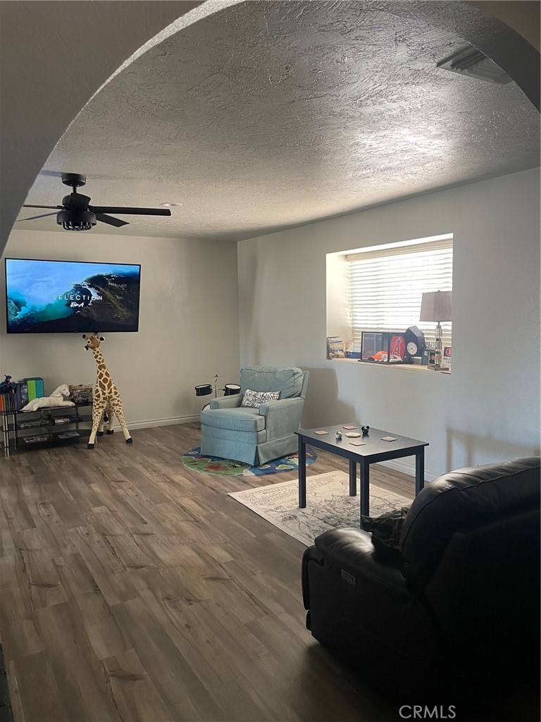 14961 Walnut Street Hesperia, CA 92345 - Photo 7 of 25 a living room with furniture and a wooden floor