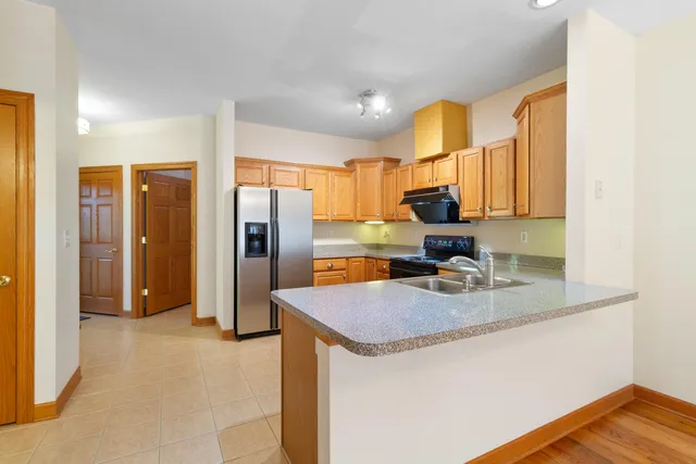 a kitchen with sink refrigerator and cabinets