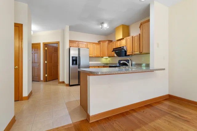 a kitchen with a refrigerator and a sink