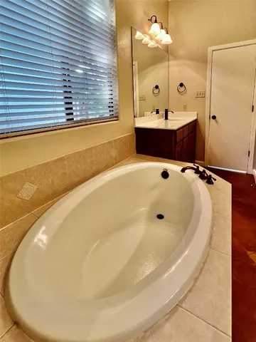 a bathroom with a bathtub and a shower