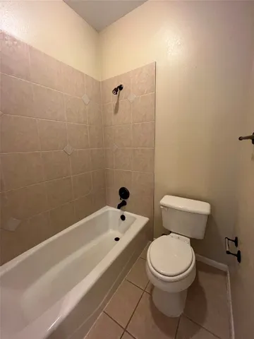 a bathroom with a toilet and a bathtub