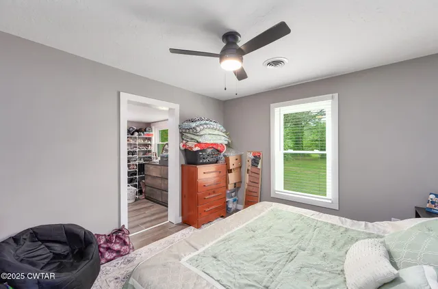 a bedroom with a bed and a large window