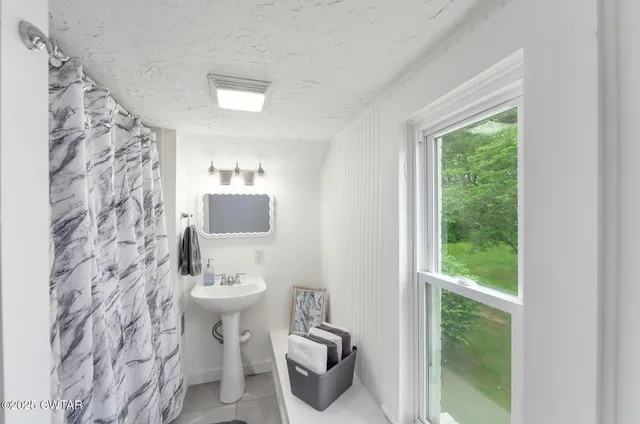 a bathroom with a sink toilet and a mirror