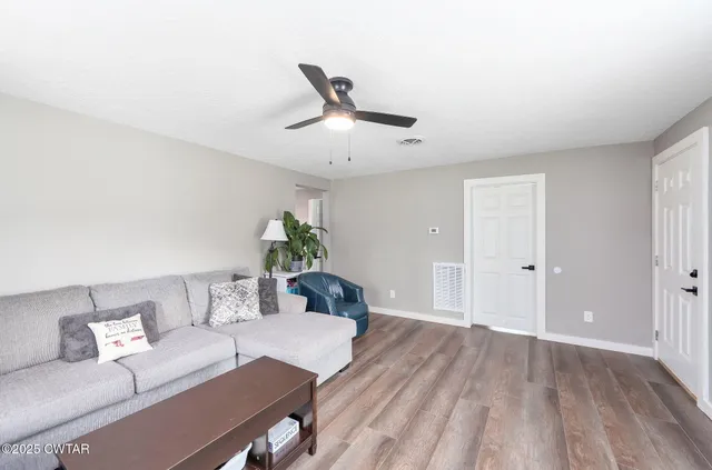 a living room with furniture and a table