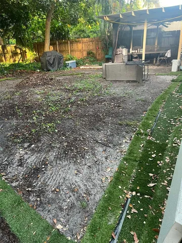 a backyard of a house with table and chairs