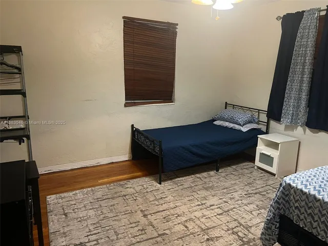 a room with a bed and a dresser