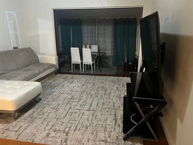 a living room with a couch and a rug