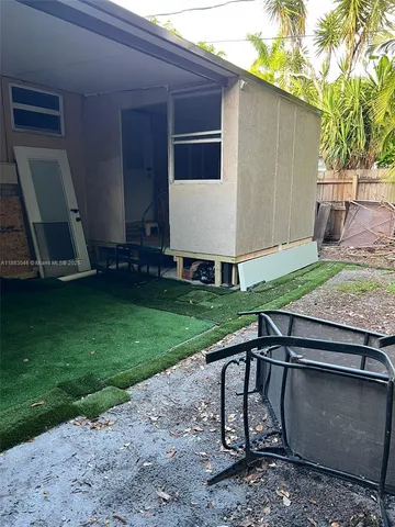 a view of backyard with a chair and a fire pit