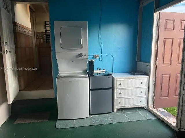 a kitchen with cabinets and a refrigerator