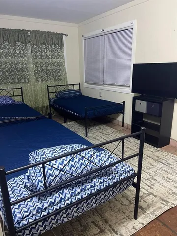 a living room with a couch and a bookshelf