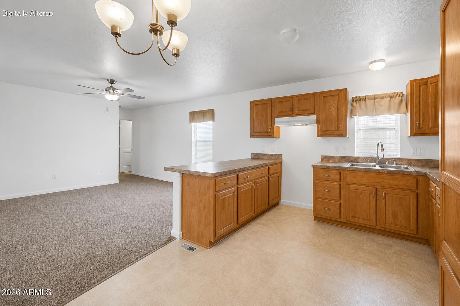 625 West McKellips Road, Unit 55 Mesa, AZ 85201 - Photo 6 of 21 a kitchen with cabinets a sink and appliances