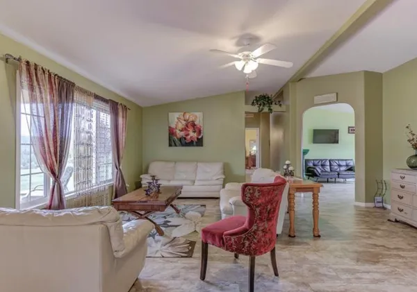a living room with furniture and a large window
