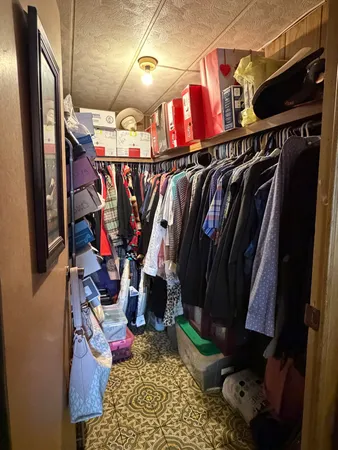 a bed sitting in a bedroom and tv
