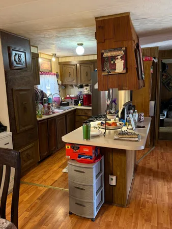 a bedroom with a bed and dresser with mirror