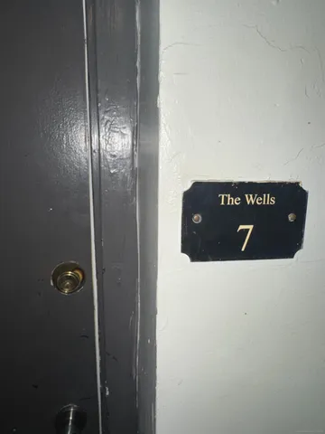 a view of bedroom with wooden floor