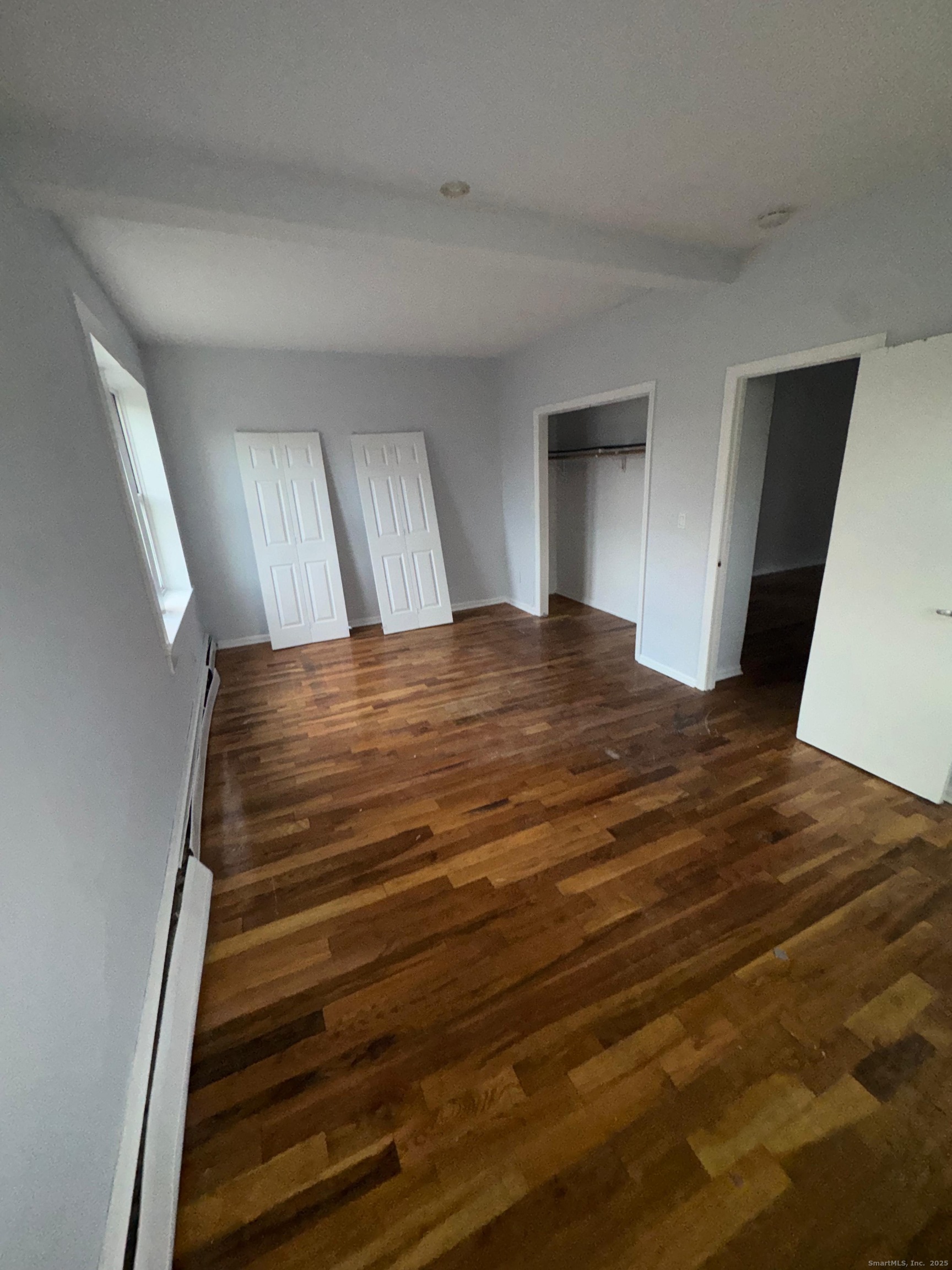 335 Wells Street, Unit W7 Bridgeport, CT 06606 - Photo 3 of 4 a view of bedroom with wooden floor