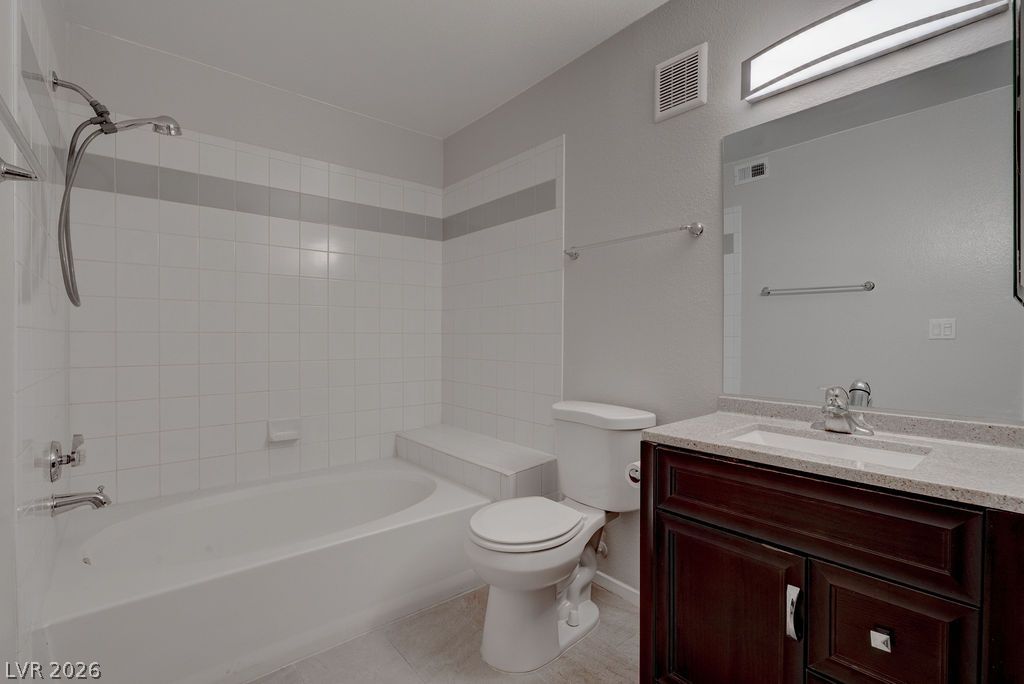 7885 West Flamingo Road, Unit 1016 Las Vegas, NV 89147 - Photo 18 of 24 A well-appointed bathroom features a practical shower-over-tub combination and a vanity with ample storage.