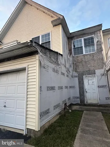 a view of a house with a door and a yard