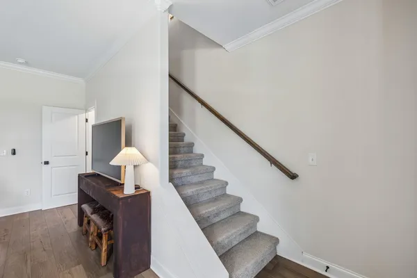 a view of entryway and hall with wooden floor