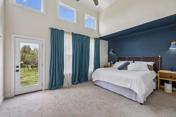 a spacious bedroom with a bed and a window