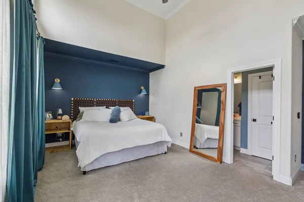 a bedroom with a bed and a mirror