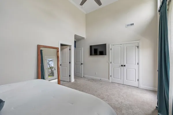 a bedroom with a bed and cabinets